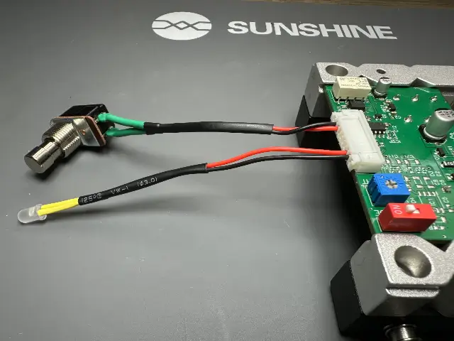 Production test harness with its footswitch and LED plugged into the IO Board